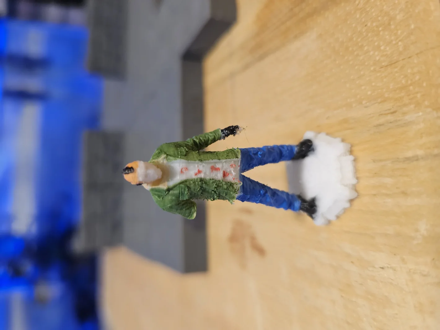 Photograph of the first painted tabletop figure during development; one arm still needs repair