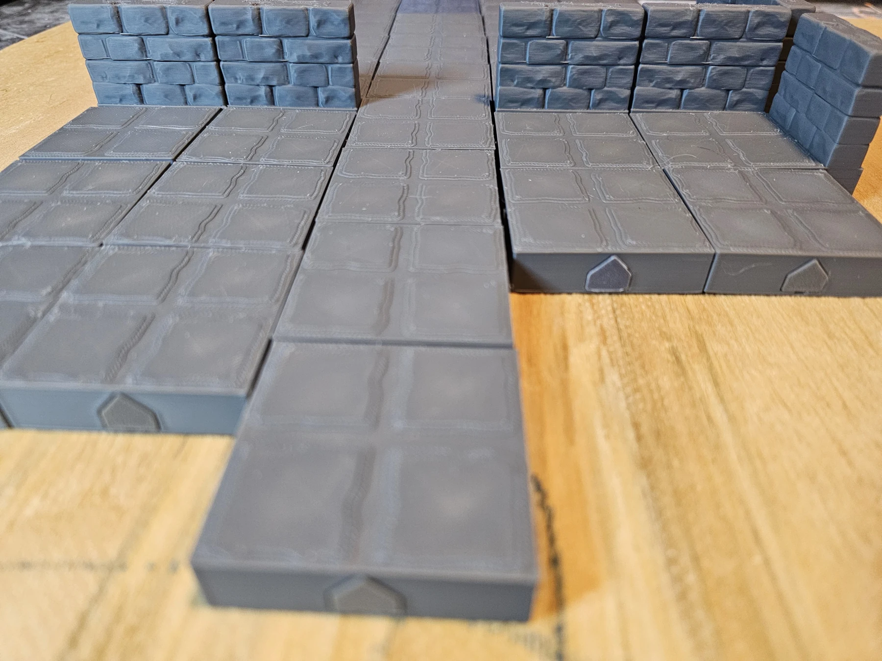 Close-up of assembled floor tiles meeting wall sections.