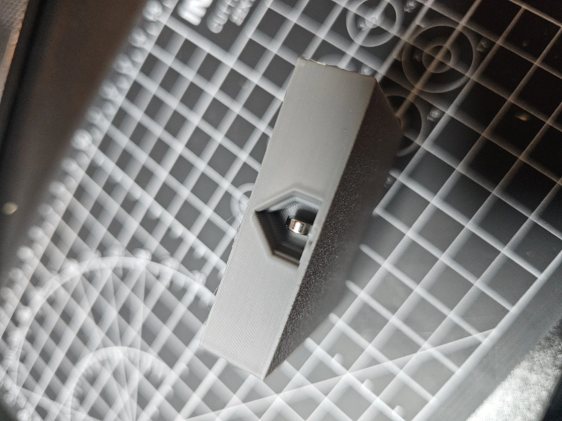 Close-up of a floor tile opening or internal access feature.